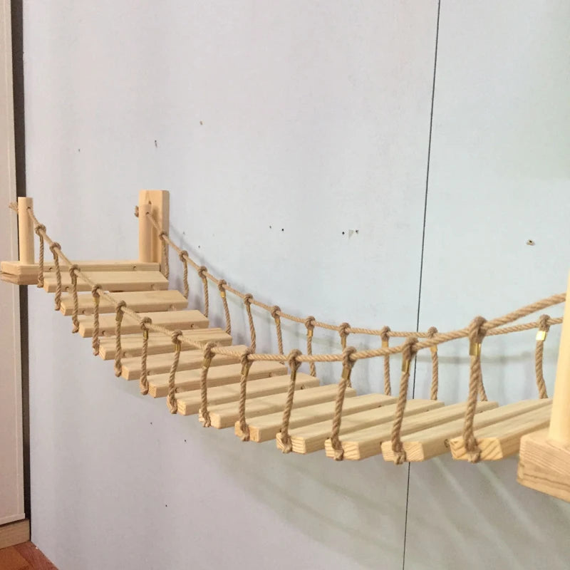 Cat crossing a wall-mounted pine and sisal bridge