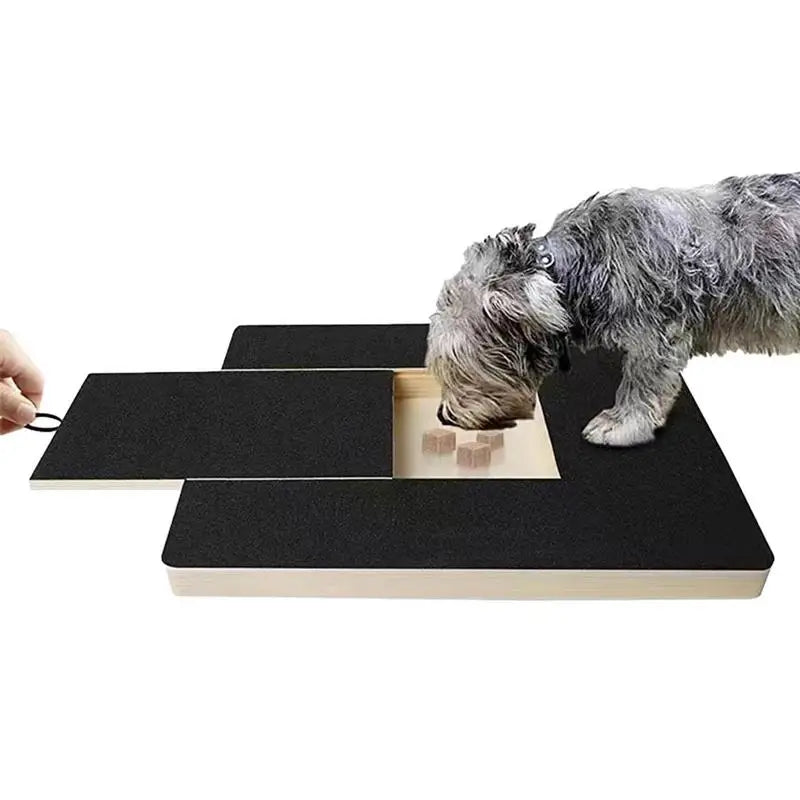 Dog reaching the treat recess on a pull-out scratch board