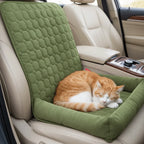 Green quilted pet car bed with a cat