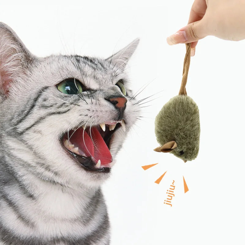 Cat batting the long tail of a plush mouse toy