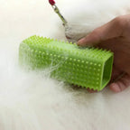 Green textured brush lifting loose pet hair