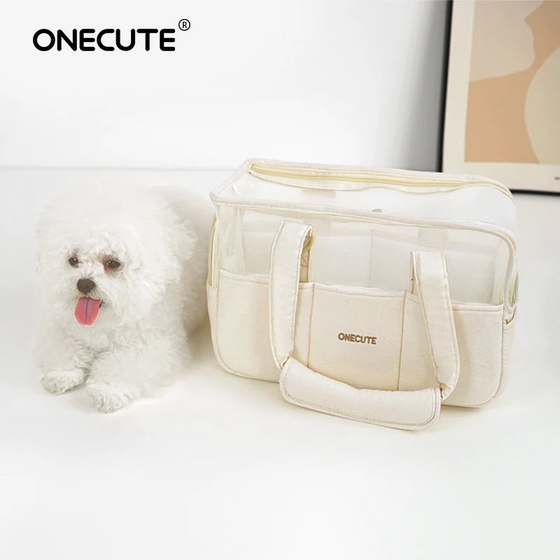 Cream pet tote carrier beside a small white dog