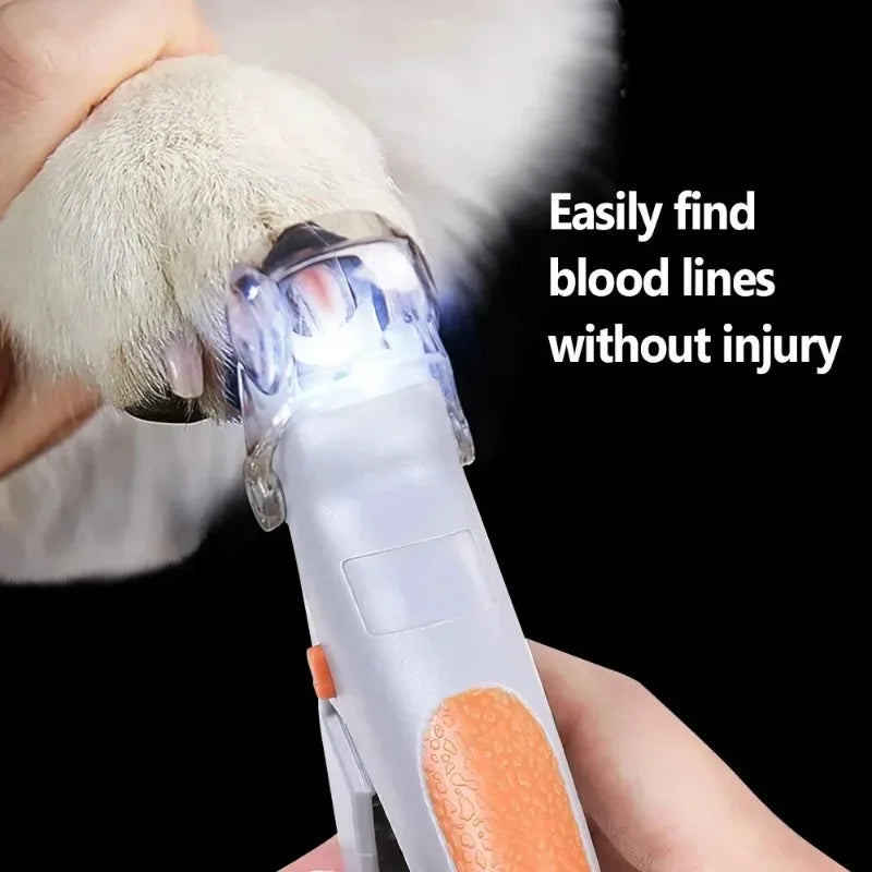 Gray and orange LED nail clipper trimming a light-colored pet nail