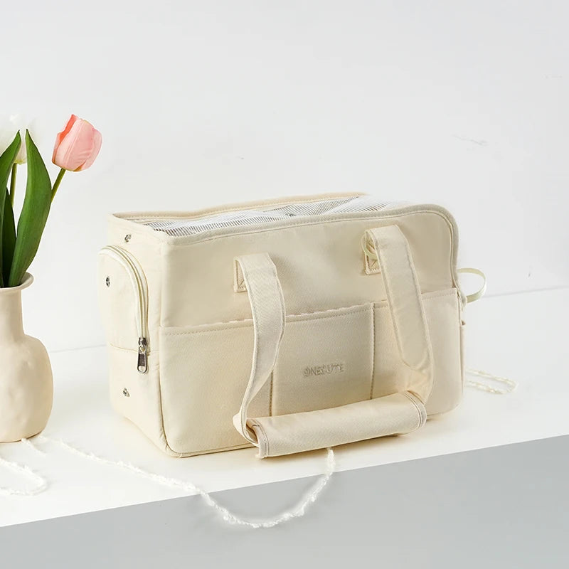 Beige cotton carrier tote with small pet