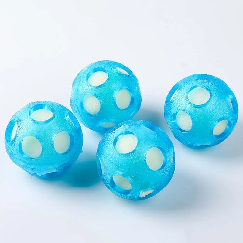 Four aqua floating dog balls on a light background