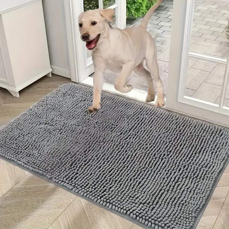 Dog entering over a large gray microfiber mat