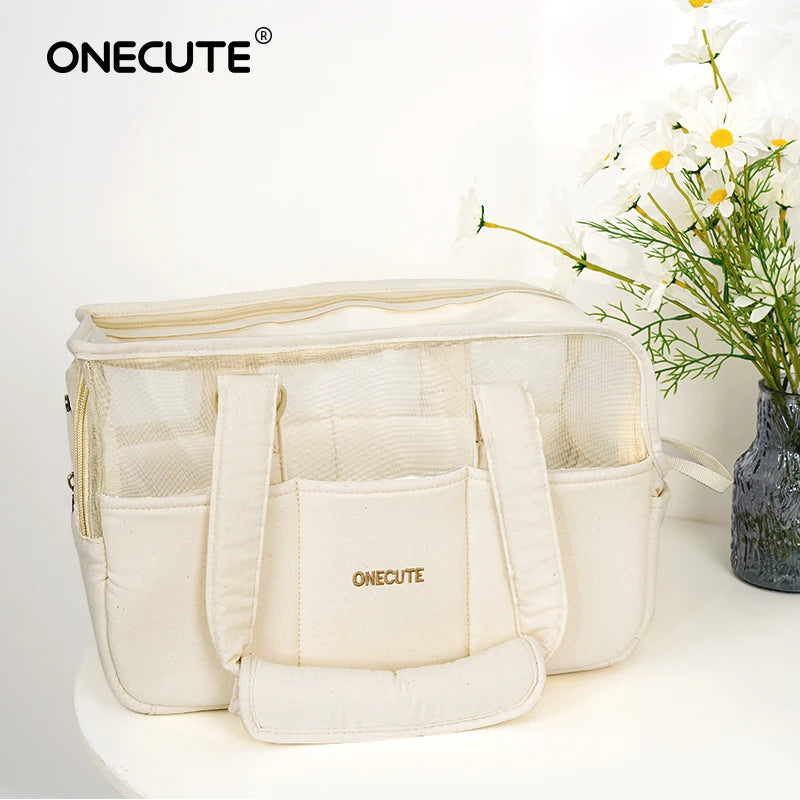 Front view of the cream mesh-panel pet tote