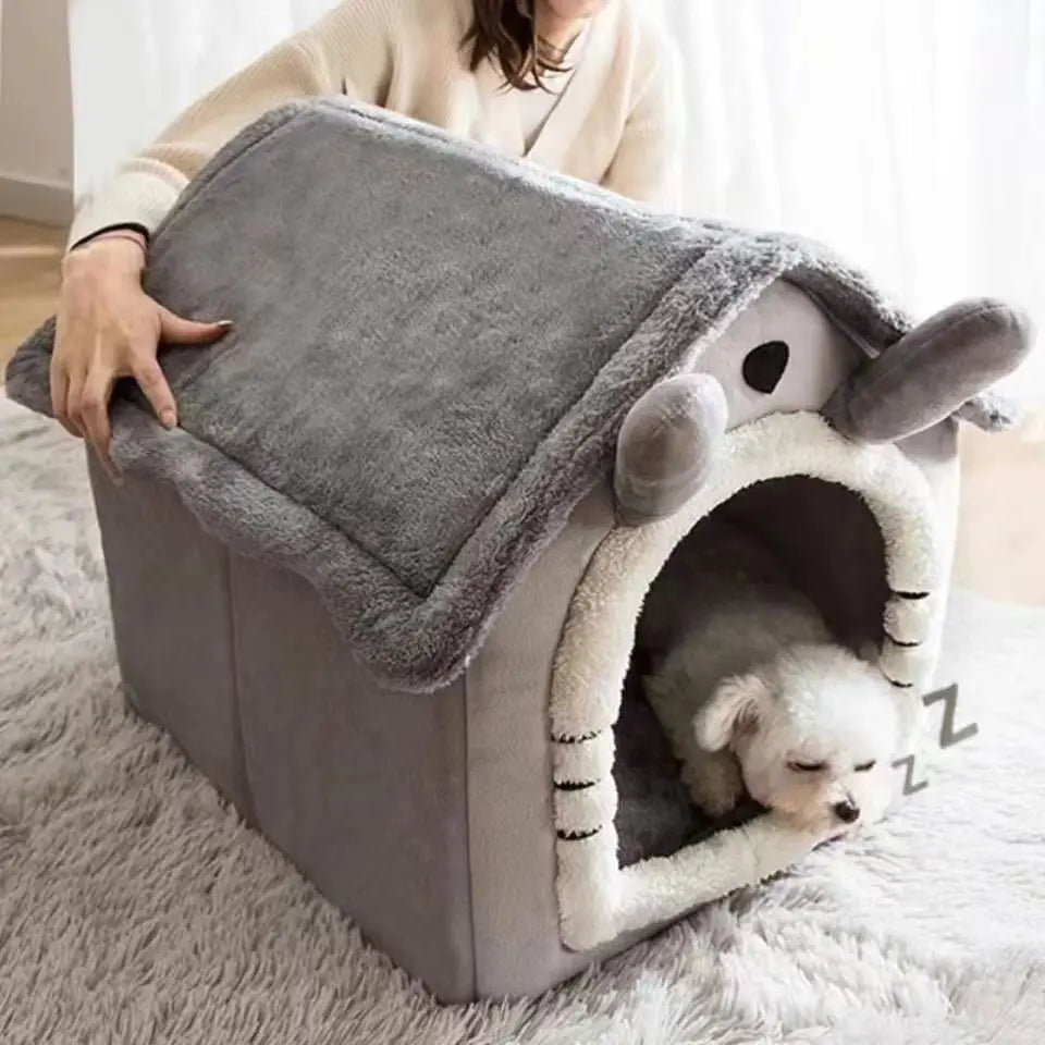 Gray plush house bed with a small dog resting inside