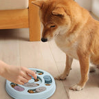 Dog using a round sliding treat puzzle