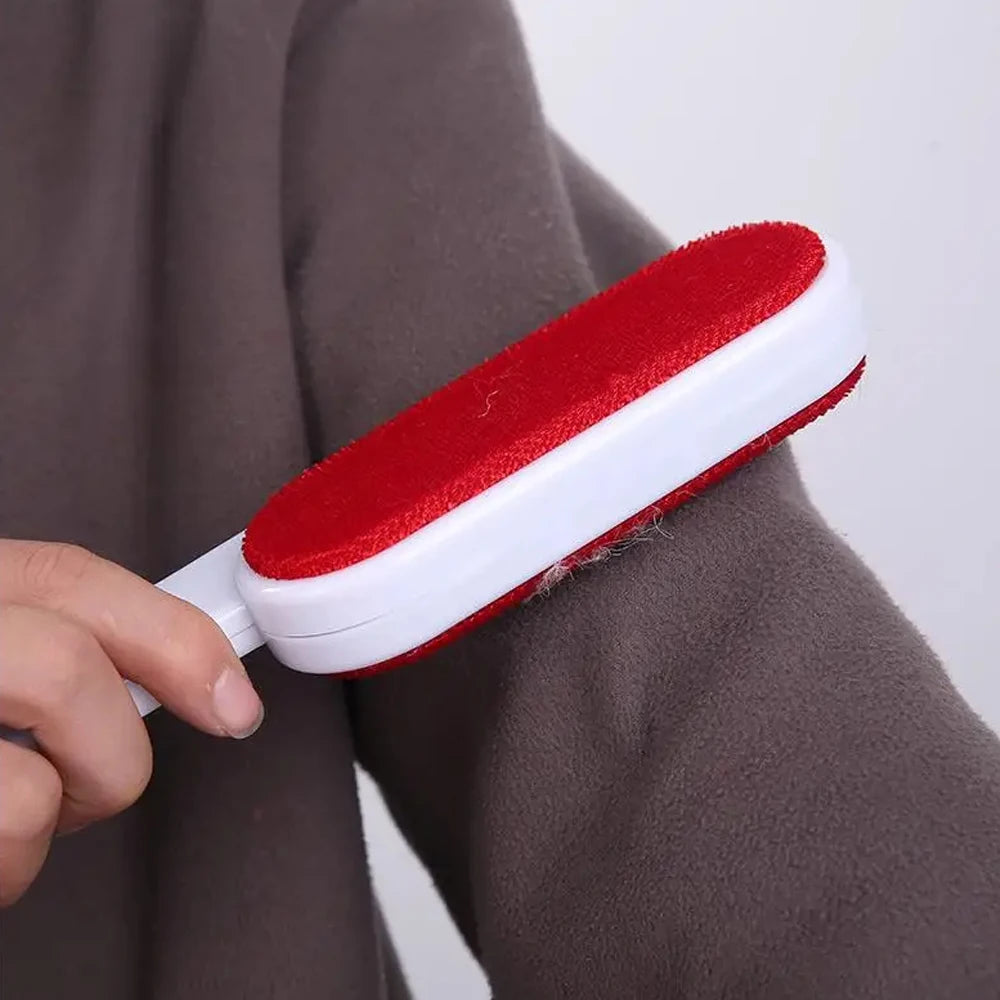 Two-sided directional lint brush sweeping a dark garment