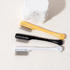 Black, yellow, and white pet facial combs